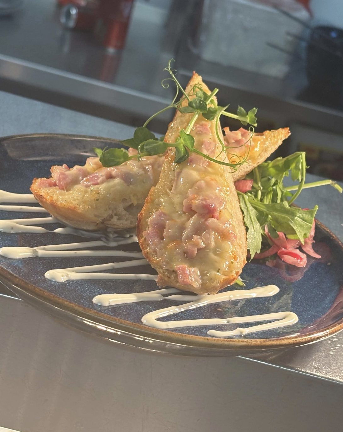 Bacon and cheddar garlic bread with rocket, pickled shallot and aioli
